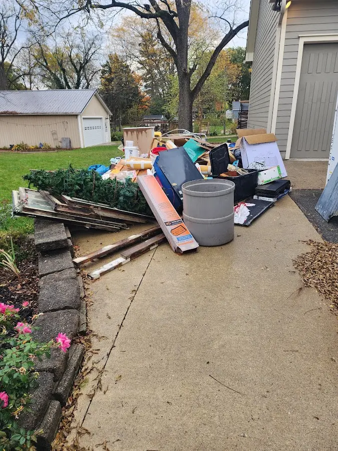 Dumpster being loaded with debris for 12 Yard Dumpster Rental in Aurora